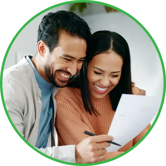 couple-smiling-reading Couple smiling while reading a document